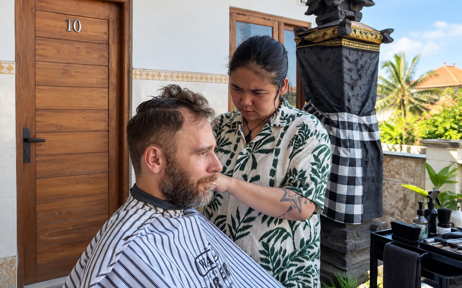 Barber cutting hair at a villa in Bali